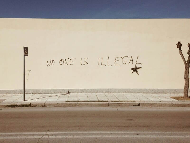 Immigration policy in the united states: no one is illegal painted on a wall
